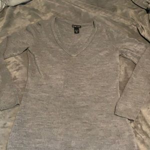 Medium grey v neck sweater.